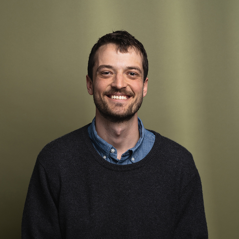 Headshot of Connor Slover with green background