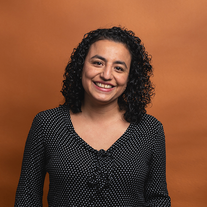 Headshot of Jannet Arevalo with orange background