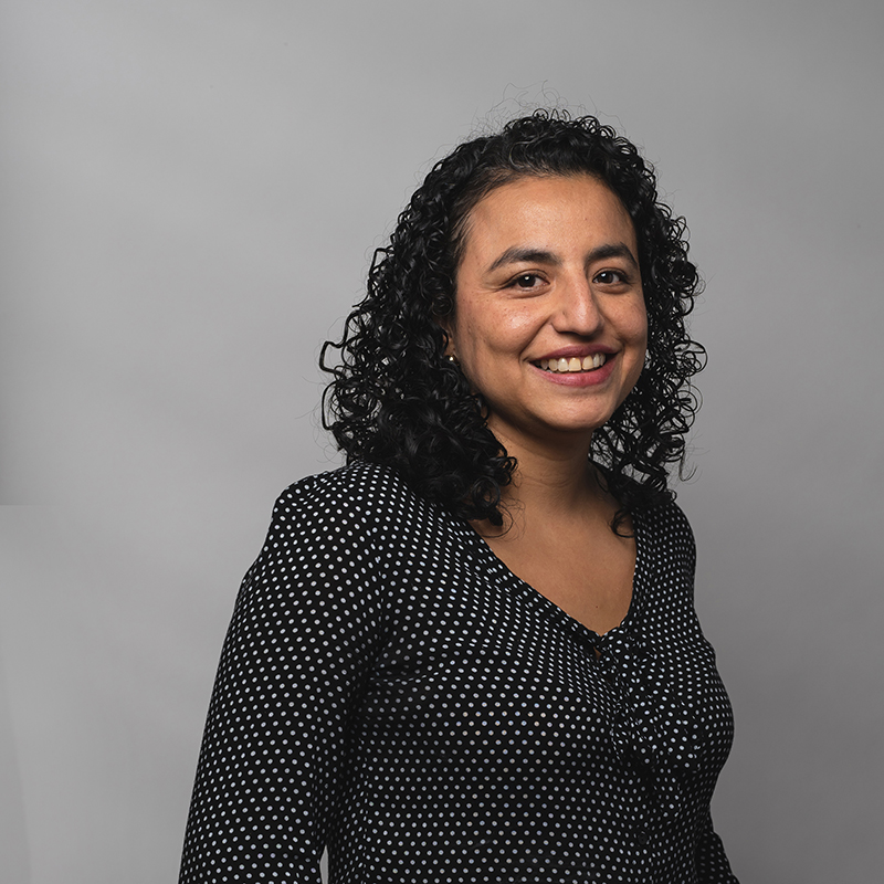 Headshot of Jannet Arevalo with dark gray background