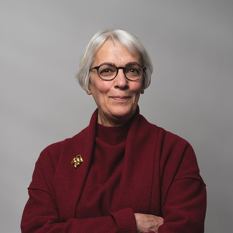 Headshot of Jean Carroon with dark gray background