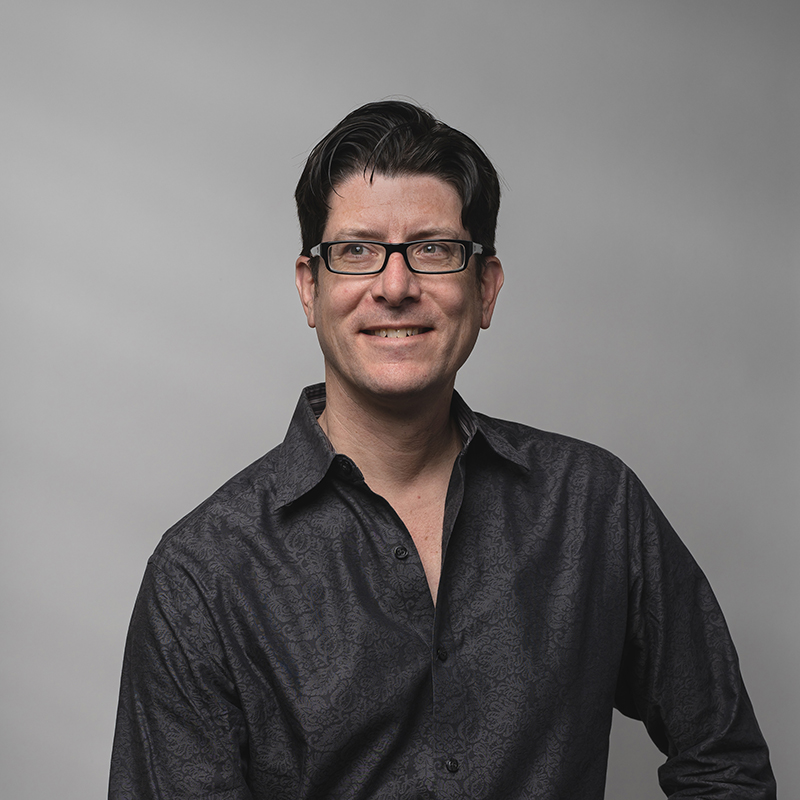 Headshot of Jefferson Poole with dark gray background