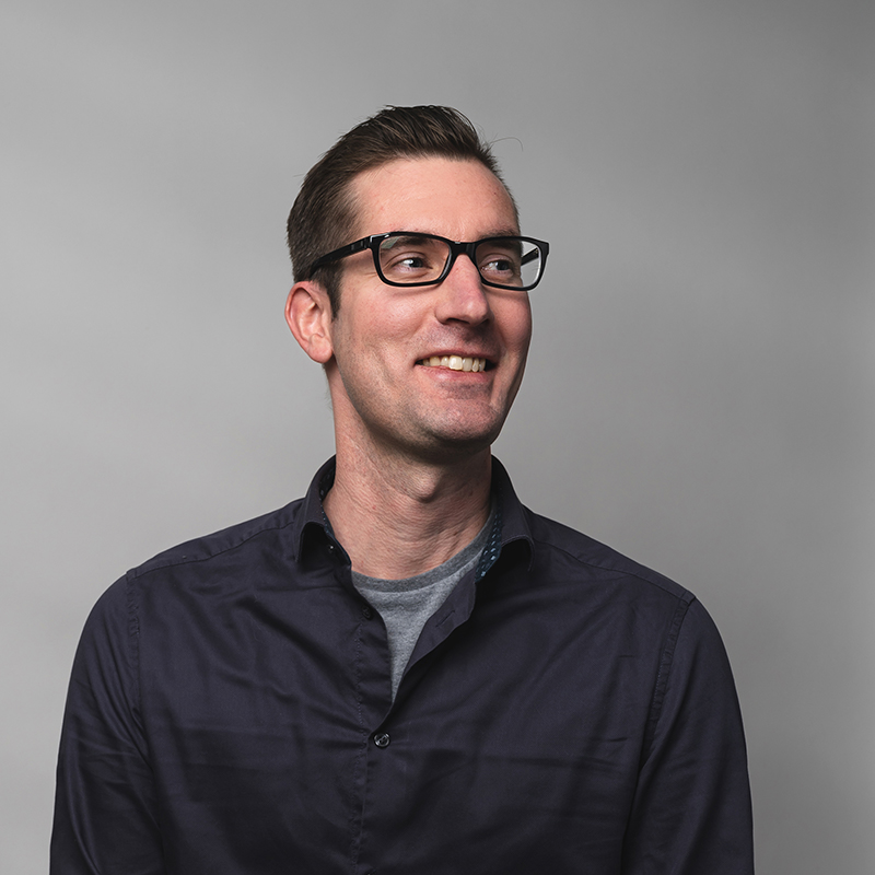 Headshot of Justin Dufresne with gray background