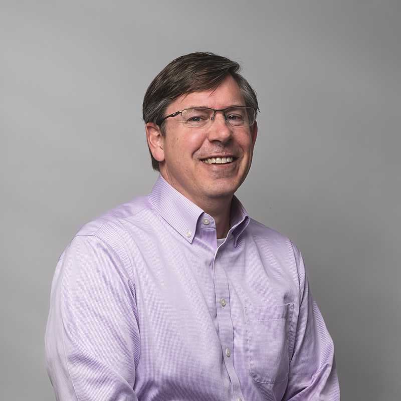 Headshot of Todd Symonds with gray background