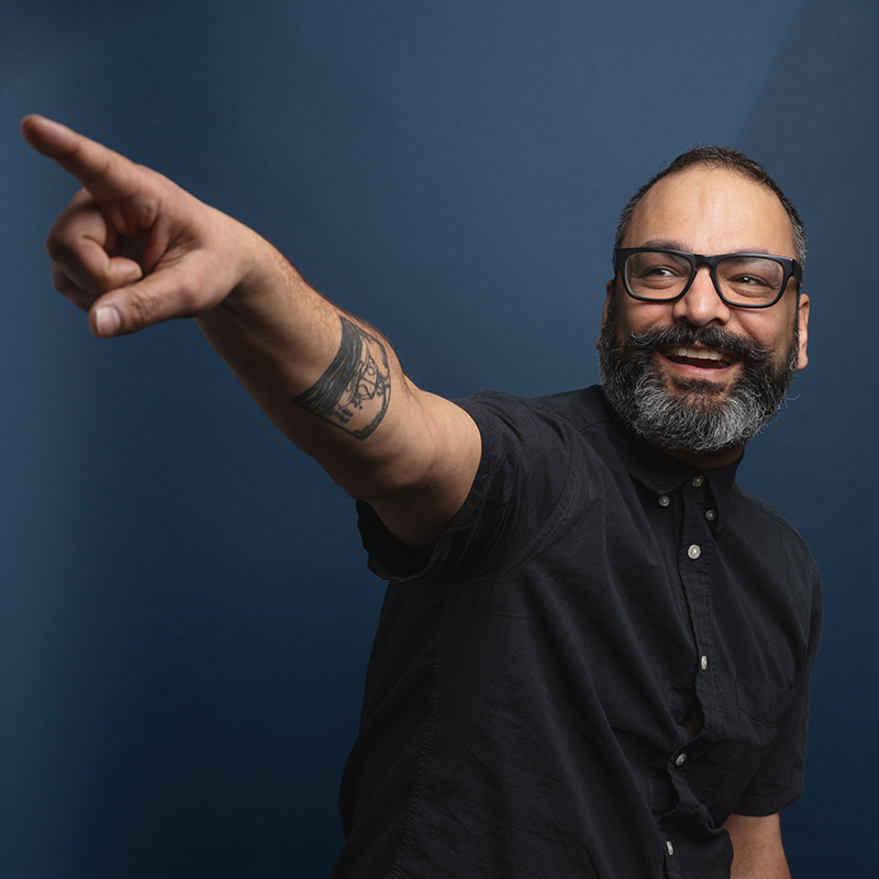 Headshot of Arjun Mande with dark blue background