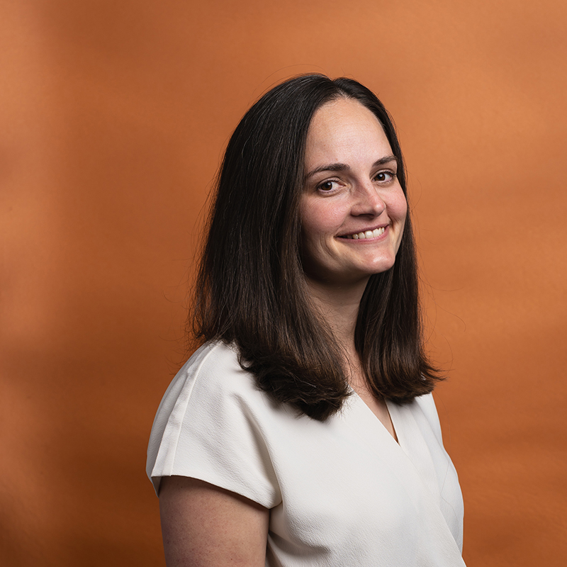 Headshot of Elaine Hoffman with orange background