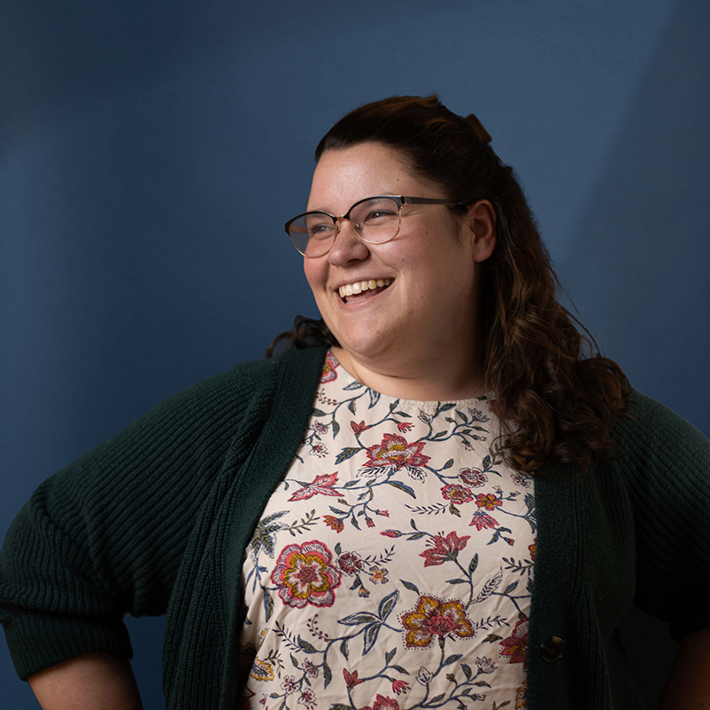 Headshot of Emily Moreau with blue background
