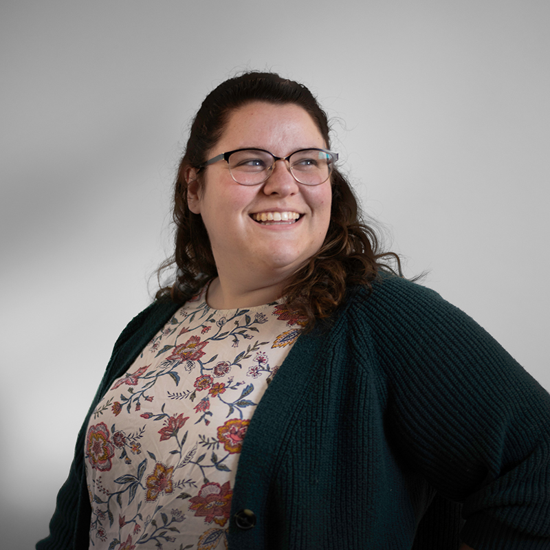 Headshot of Emily Moreau with gray background