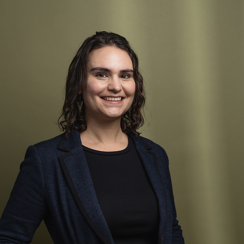 Headshot of Hannah Levine with green background