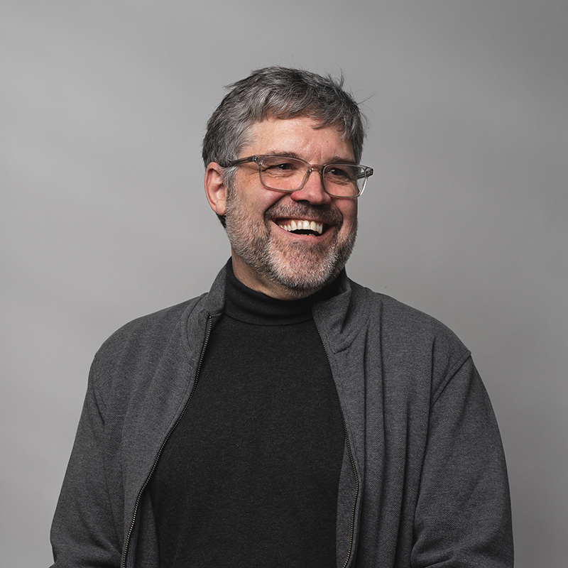 Headshot of Jeff Millett with dark gray background