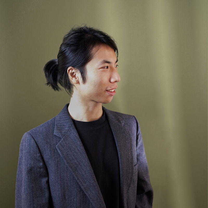 Headshot of Jiewei Li with green background