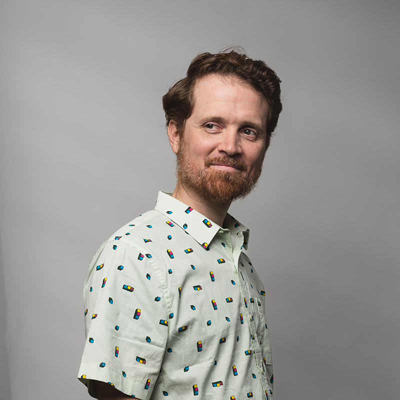 Headshot of Josh Swasey with gray background