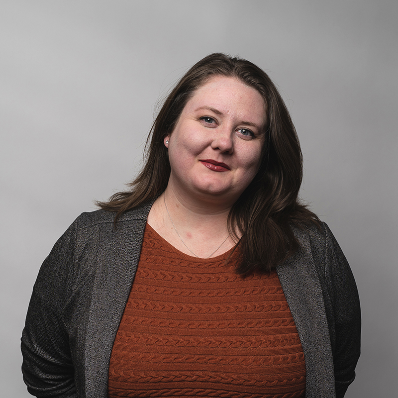 Headshot of Kristen Caulk with gray background