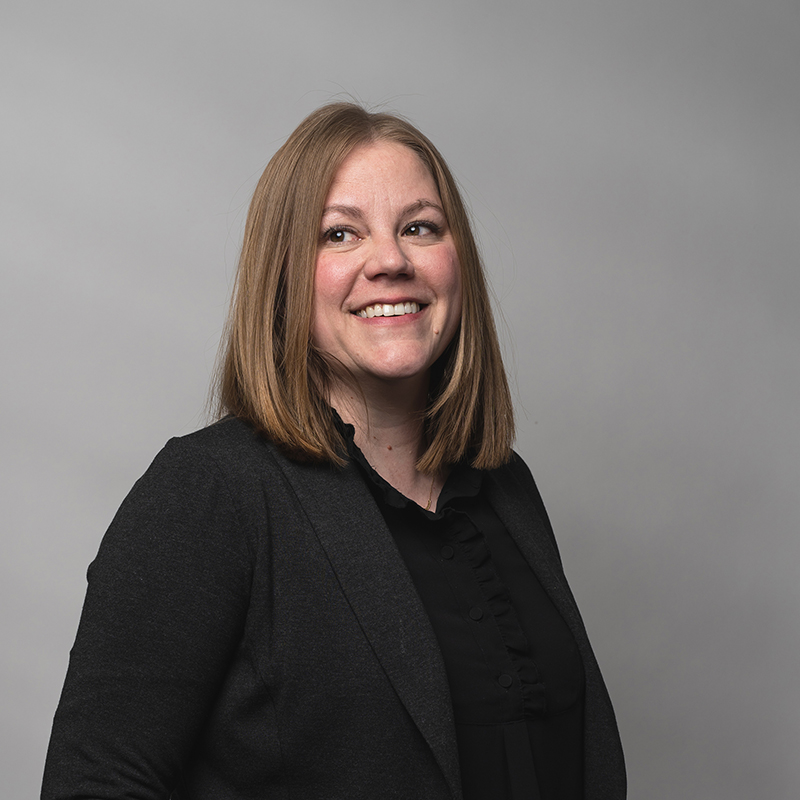 Headshot of Libby Brown with gray background