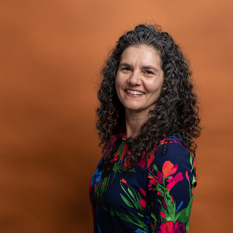 Headshot of Lisa Ferreira with orange background