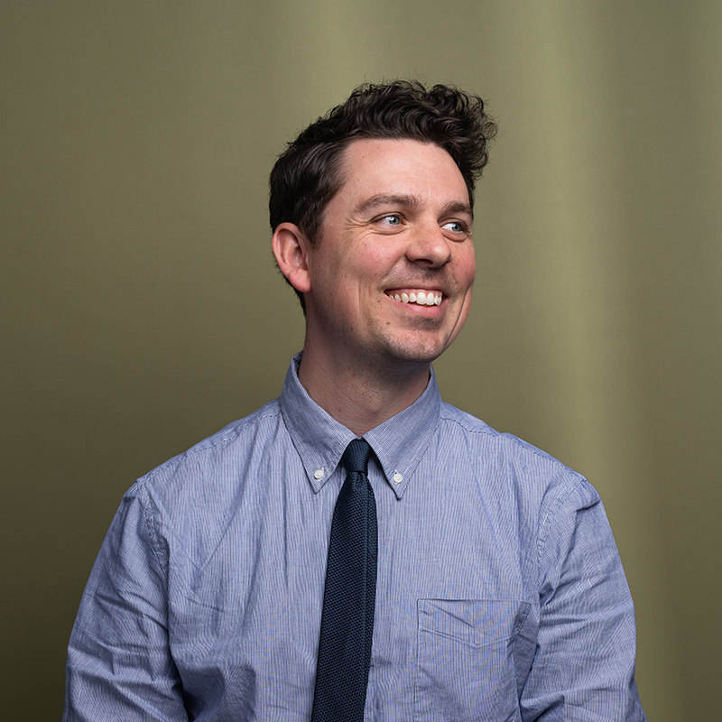 Headshot of Matthew Flynn with green background