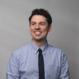 Headshot of Matthew Flynn with gray background