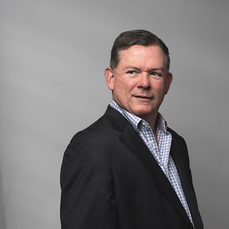 Headshot of Michael Walsh with gray background