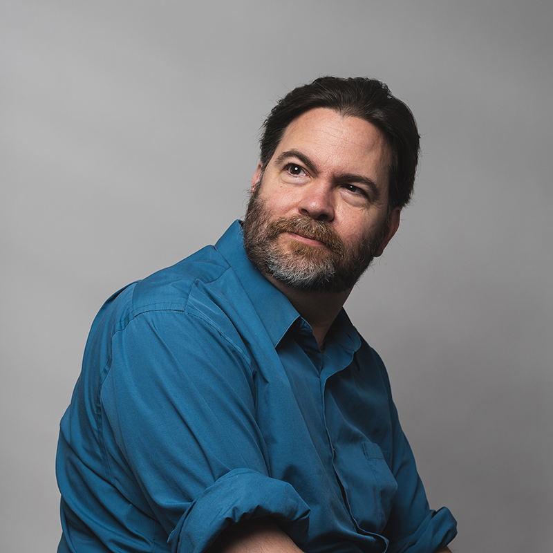 Headshot of Michael Feely with gray background