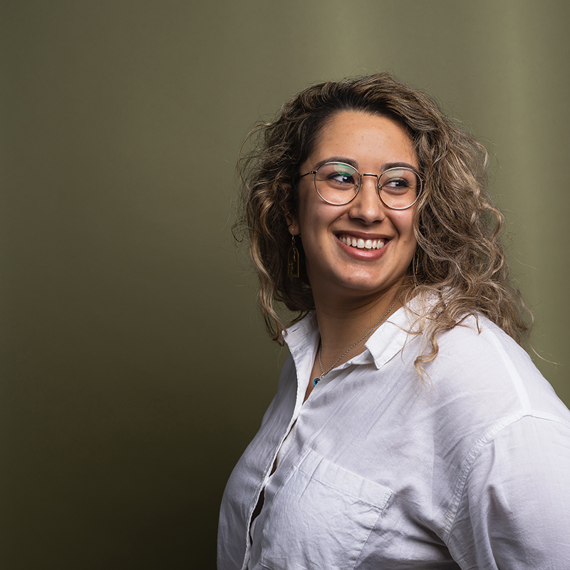 Headshot of Muna El-Taha with green background