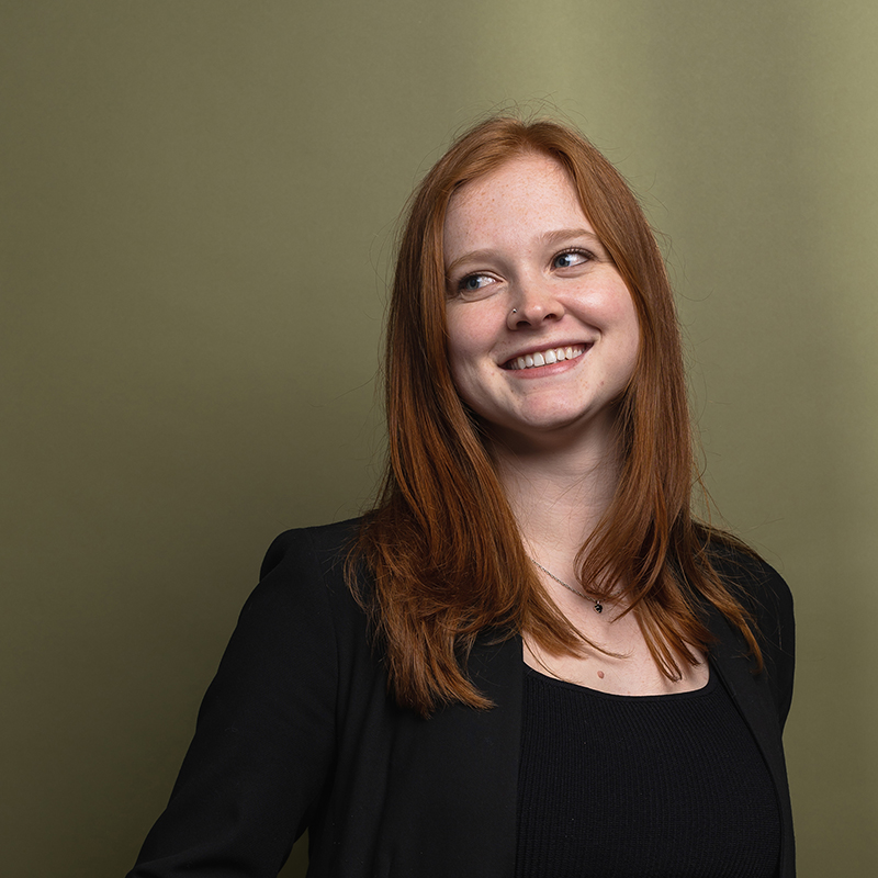 Headshot of Nina Huttemann with green background