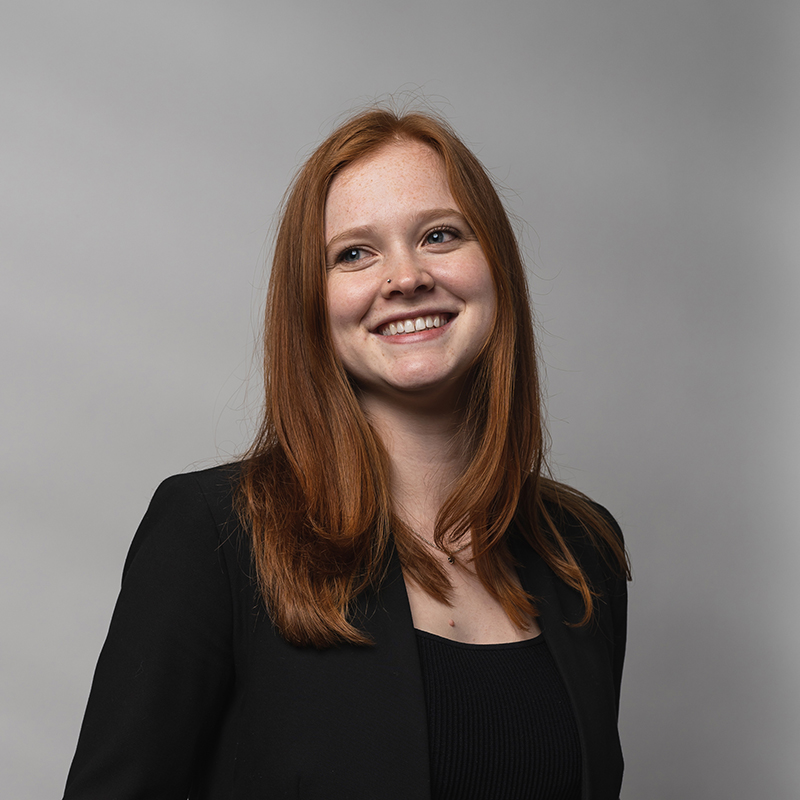 Headshot of Nina Huttemann with gray background