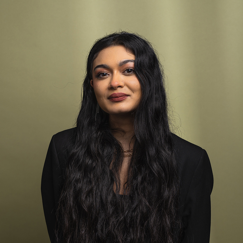 Headshot of Noor Shakeel with green background