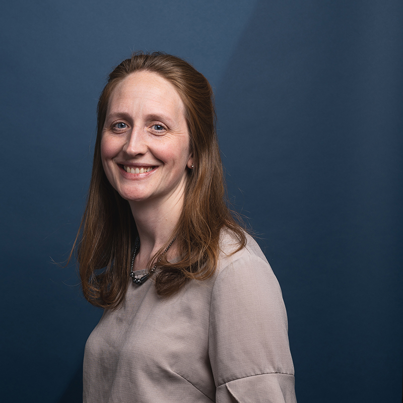 Headshot of Pamela Clemens with blue background