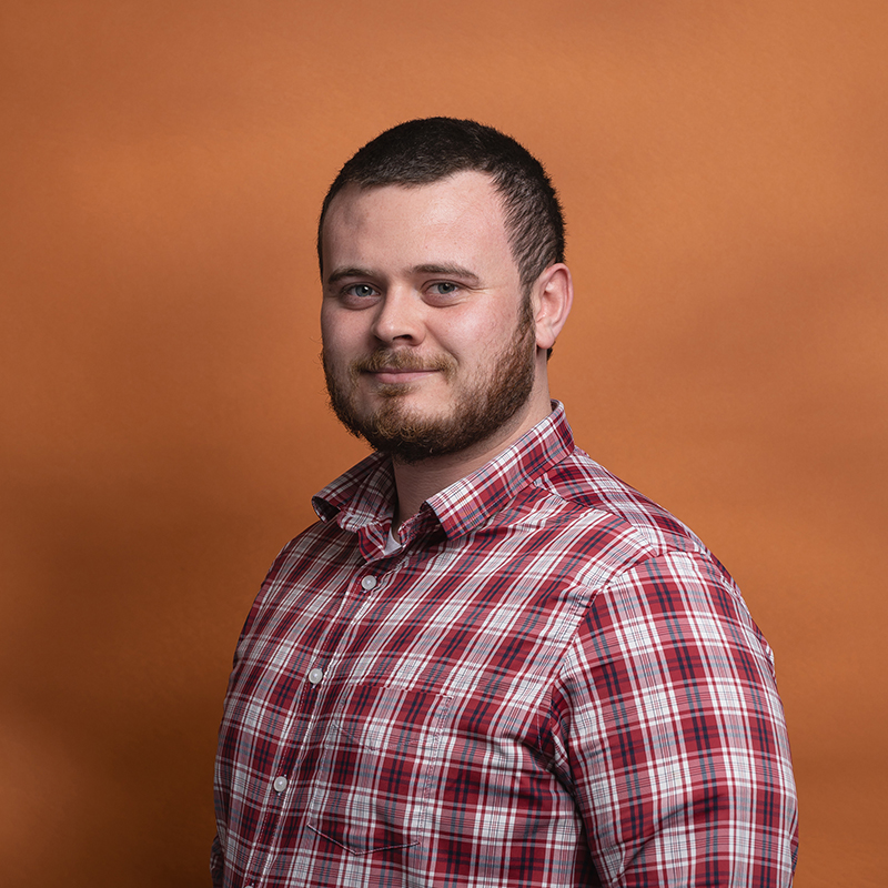 Headshot of Patrick O'Connor with orange background