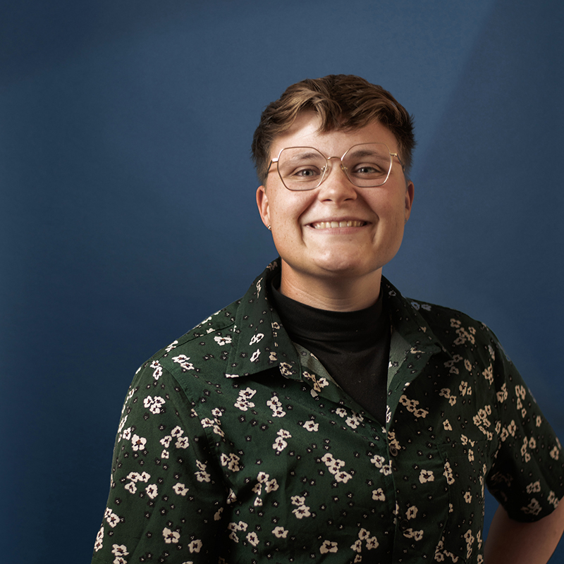 Headshot of Shannon Fay with blue background