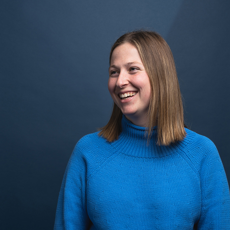 Headshot of Sydney Anderson with blue background