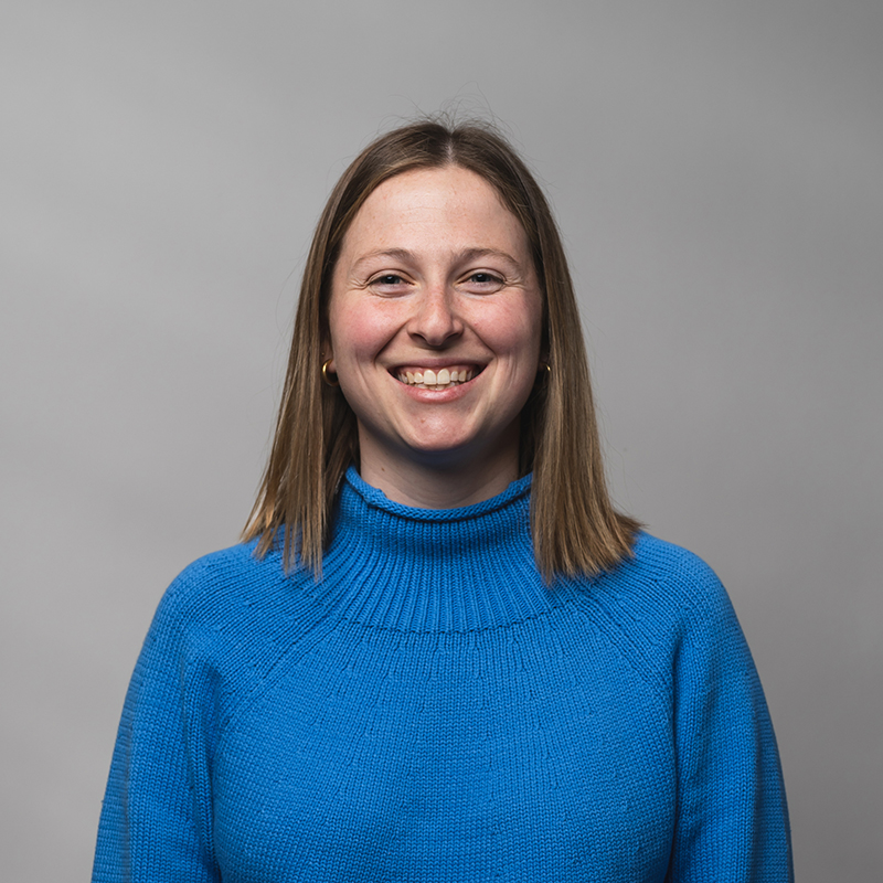 Headshot of Sydney Anderson with gray background