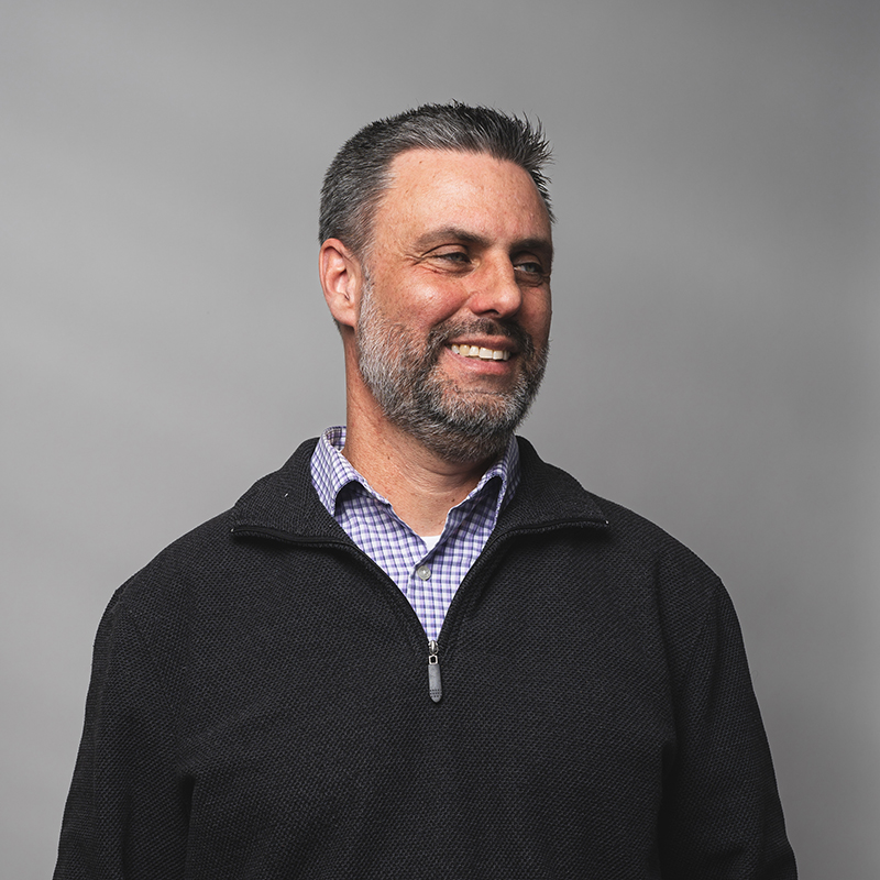 Headshot of Tom O'Brien with gray background