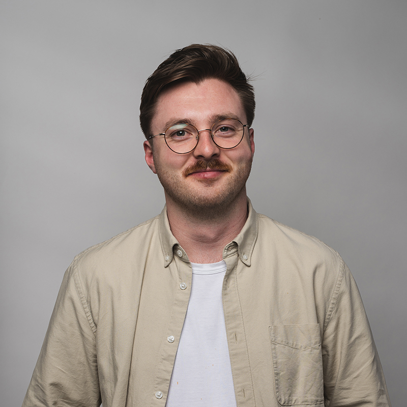 Headshot of Will Evans with gray background