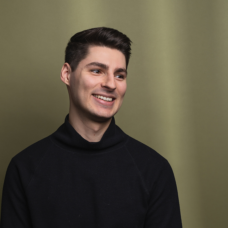 Headshot of Zac Gaudet with green background