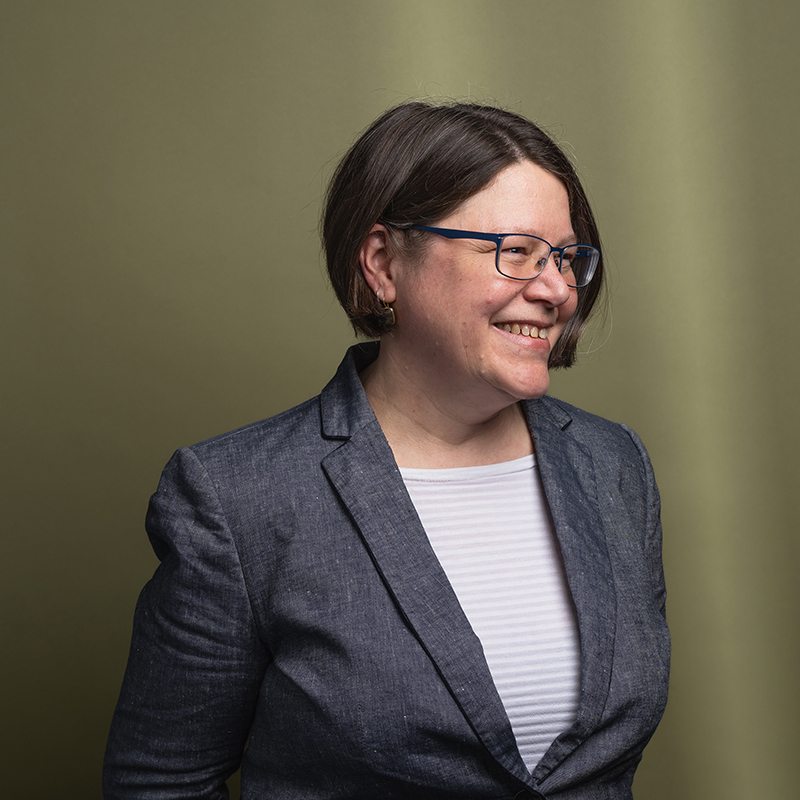 Headshot of Sara Elsa-Beech with green background