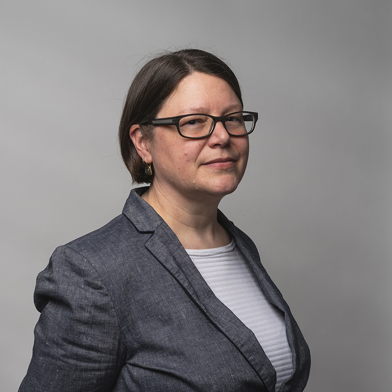 Headshot of Sara Elsa-Beech with gray background